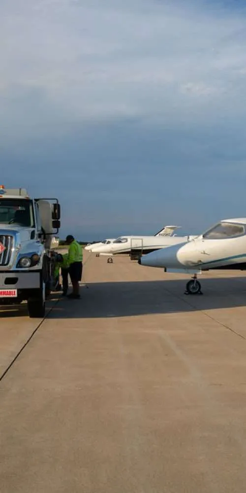 Planes parked and getting fueled up from truck outside of Columbia Jet Center.